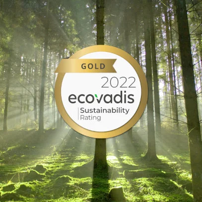 Mersen Gold EcoVadis medal with a forest in the background