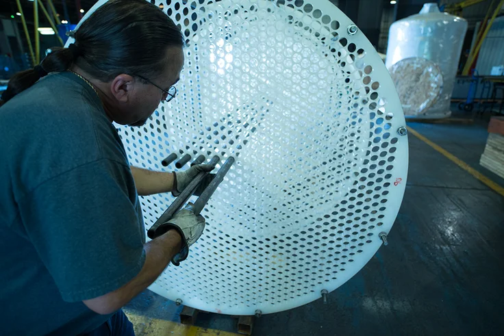 a man reparaing a shell tube