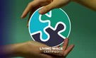 Hands holding a circular logo with interlocking puzzle pieces with Living Wage certified text.